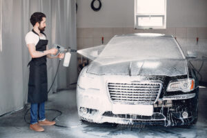 Man washing his car in a garage